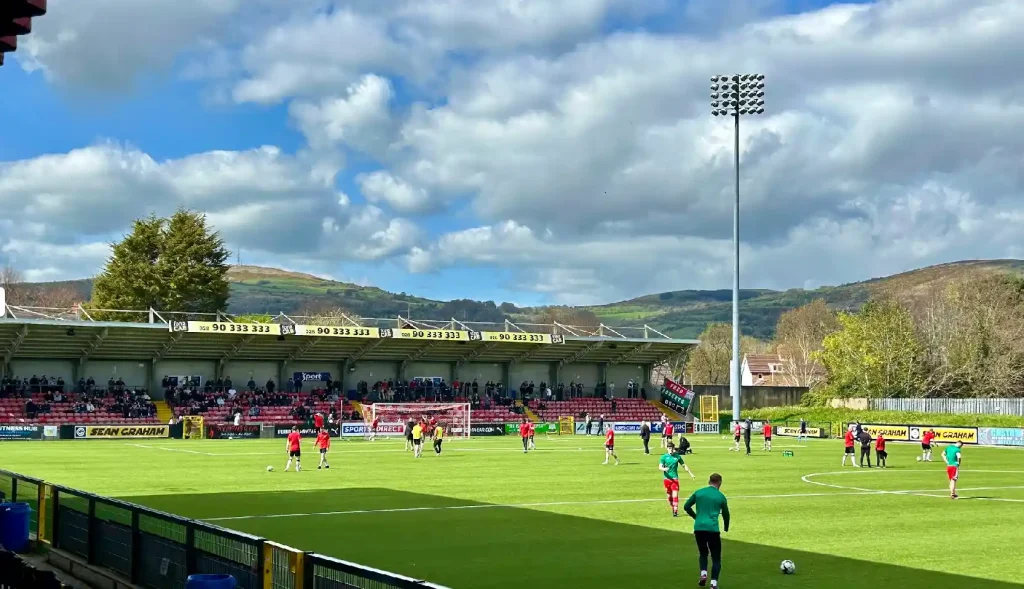 Players on a field kicking footballs around.